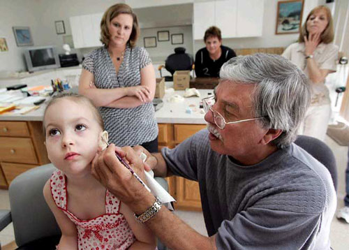 Doctor help girl get eardrum